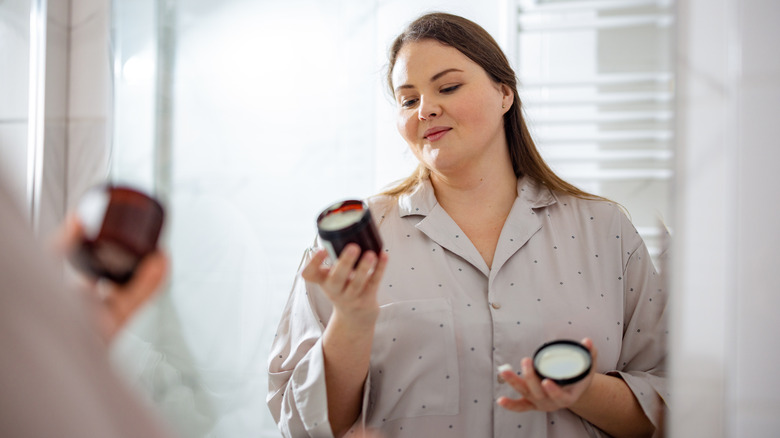 Woman reading skincare product label