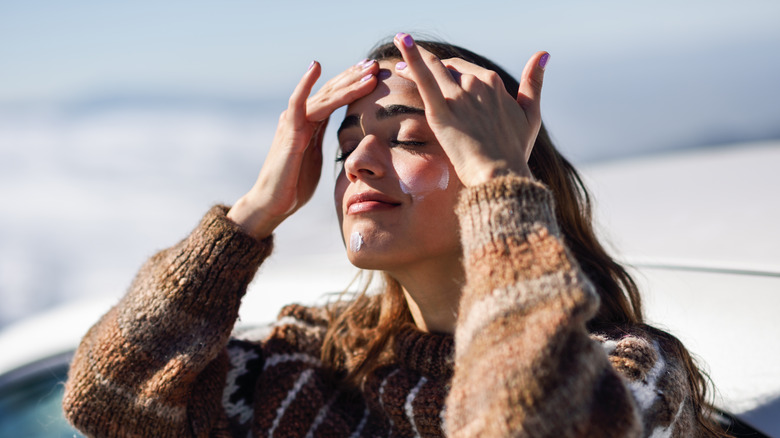 Woman applying sunscreen