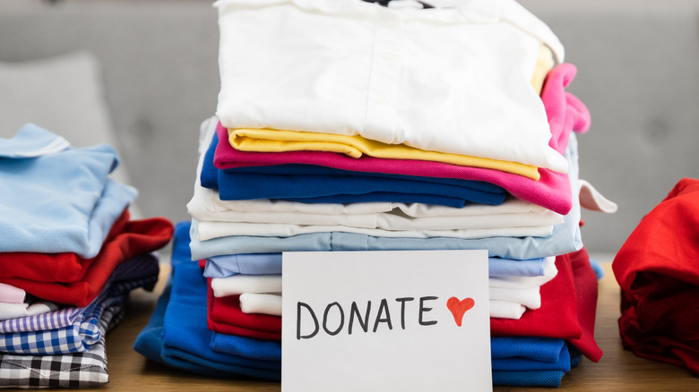 piles of clothes to keep, donate, and discard