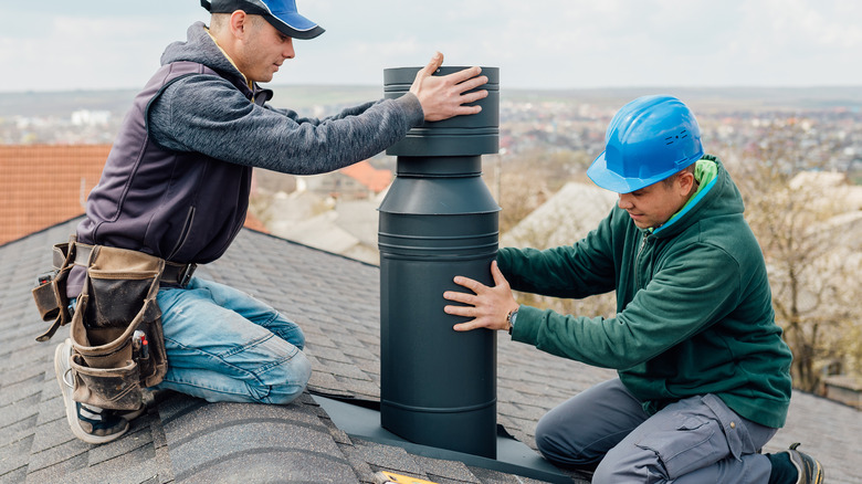 two men cleaning a chimney