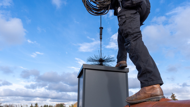 man cleaning flue