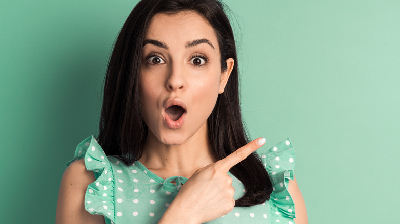 woman wearing polka dots pointing