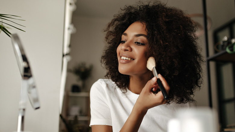 Black woman applying contour