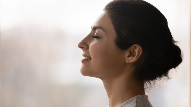 A smiling woman with her eyes shut 