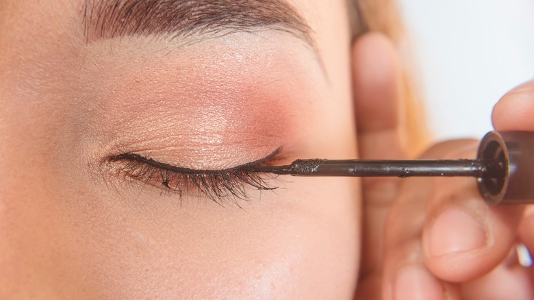 liquid eyeliner being applied to a model