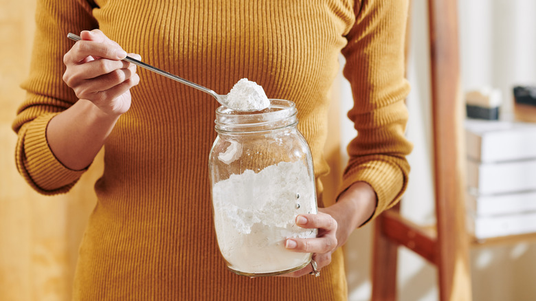 woman holding baking soda jar