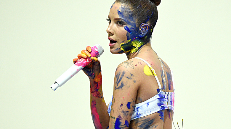 Halsey wearing body paint while performing onstage