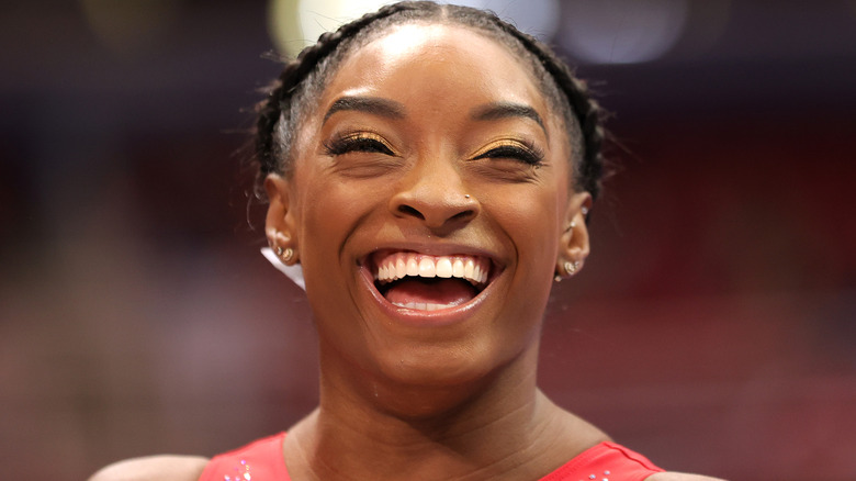 Simone Biles laughing with gold eye makeup