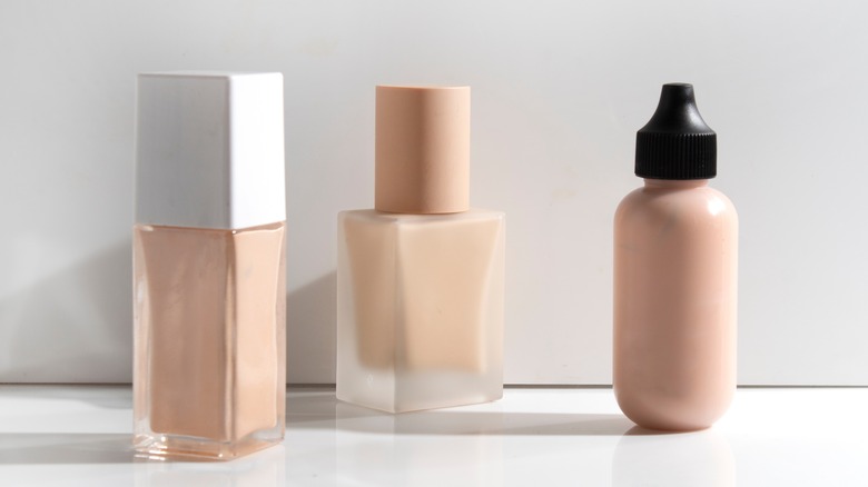 Bottles of concealer and foundation on a table