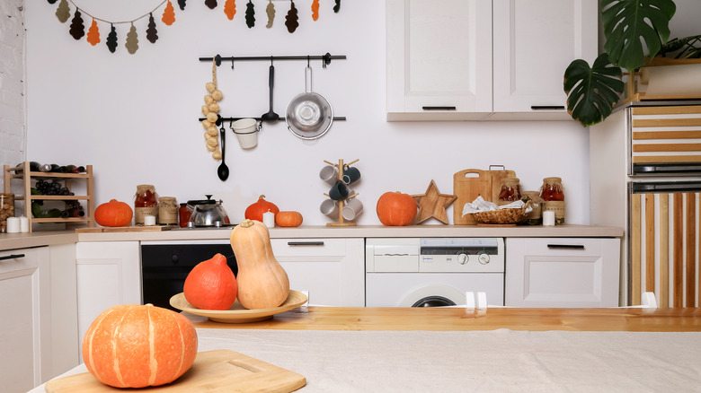 Pumpkins sitting on a kitchen counter