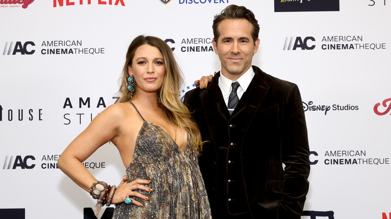 Blake Lively and Ryan Reynolds posing at awards