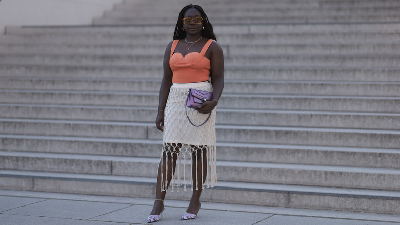 orange bustier and white skirt