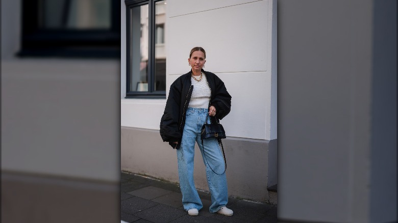 A woman posing in baggy jeans 