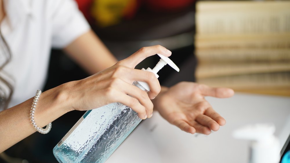 Woman cleaning her hands after using the toilet