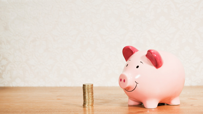 Pink piggy bank with coins