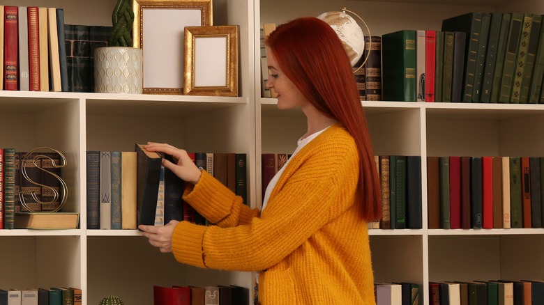 Woman organizing book collection