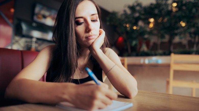 Woman writing a list