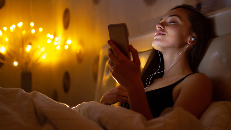 Woman listens to music before bed