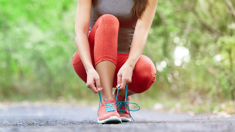 Woman tying her exercise shoes