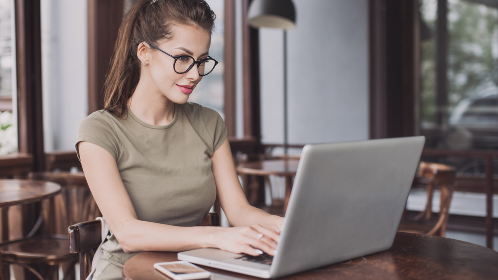 beautiful woman looking at laptop