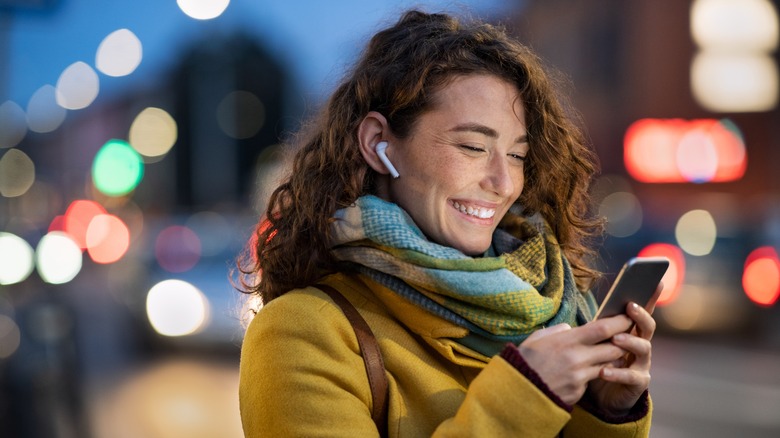 Woman smiling at phone