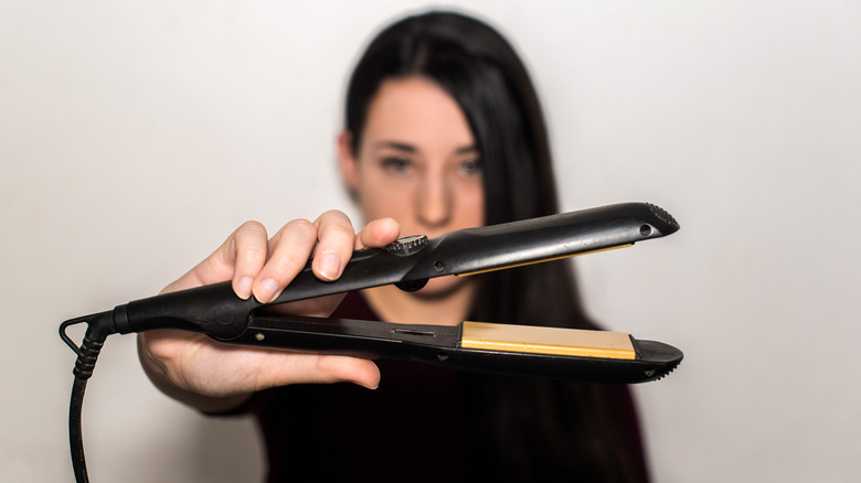 Woman holding flat iron