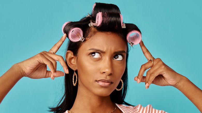 Woman wearing hair rollers