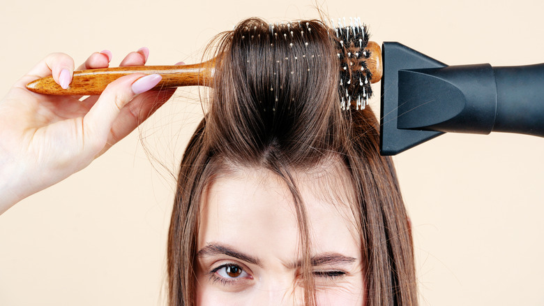 Woman blow drying hair