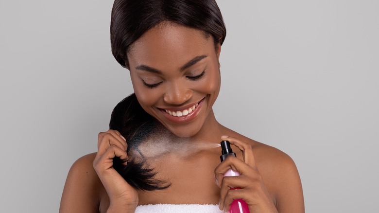 Woman applying hair product