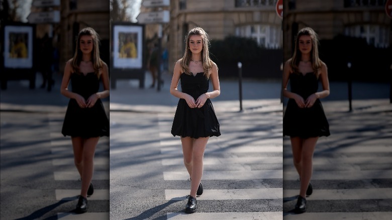 a woman in a black mini dress