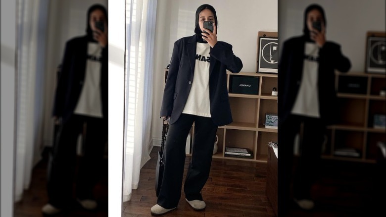 Woman taking selfie in oversized blazer