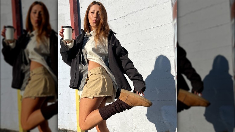 woman in front of wall with coffee