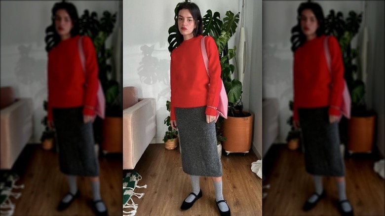 woman in red sweater and grey skirt