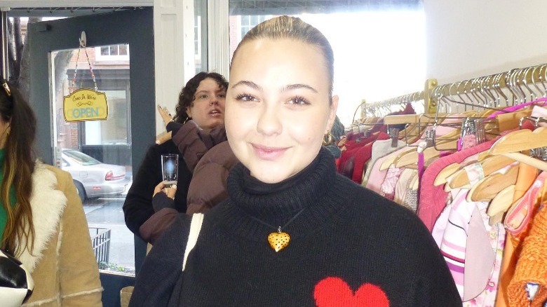 Black turtleneck and gold pendant