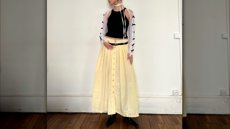 girl in long skirt and laced sleeves