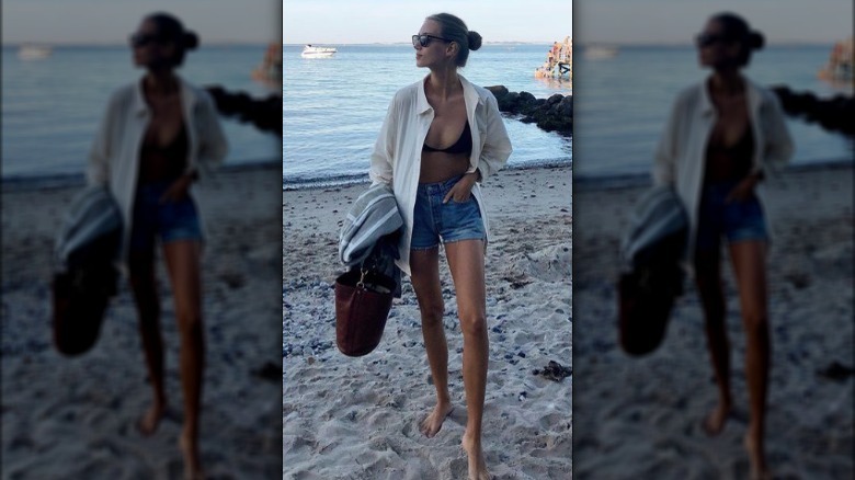 Woman on beach in denim shorts