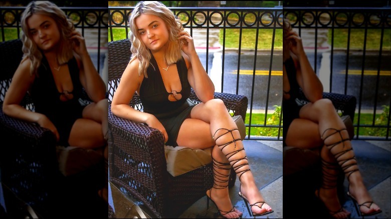 Blond wearing black dress and strappy heels 