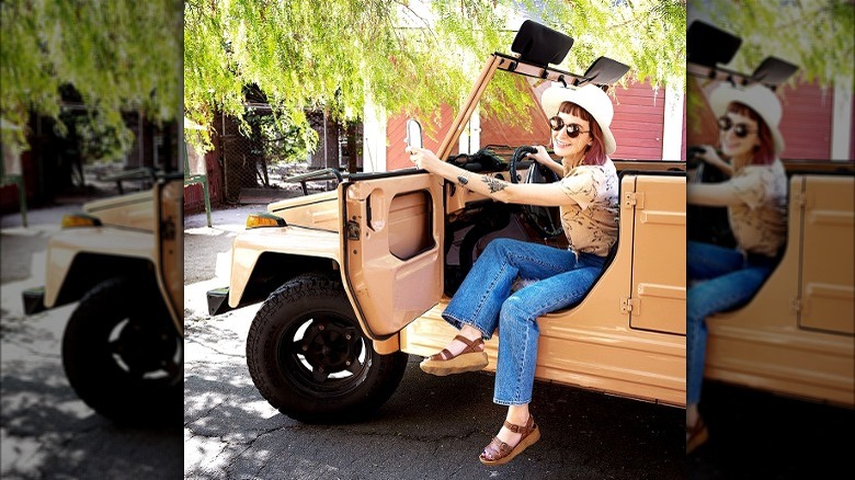 Model in tan convertible car