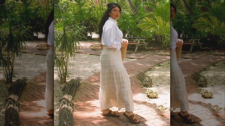 Brunette in long cream skirt and sandals