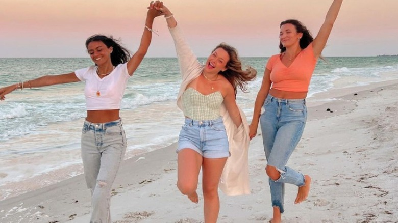 girls walking on beach