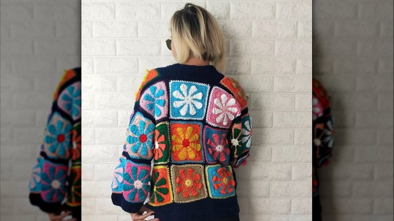 Woman with her back turned wearing vibrant sweater