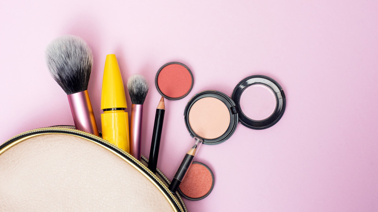 Makeup products on pink background 
