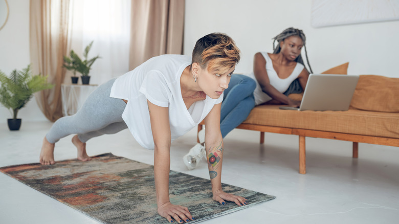 woman planking woman on computer