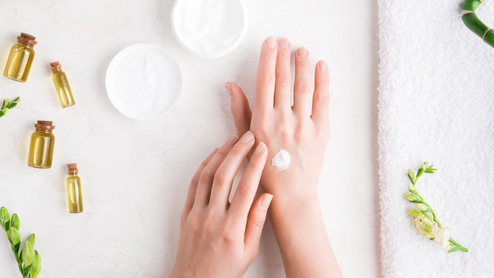 Woman applying hand cream