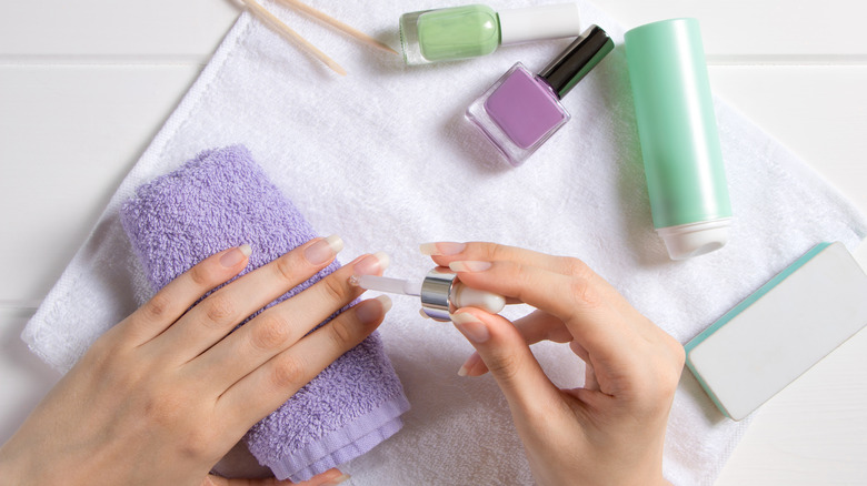 woman applying cuticle 