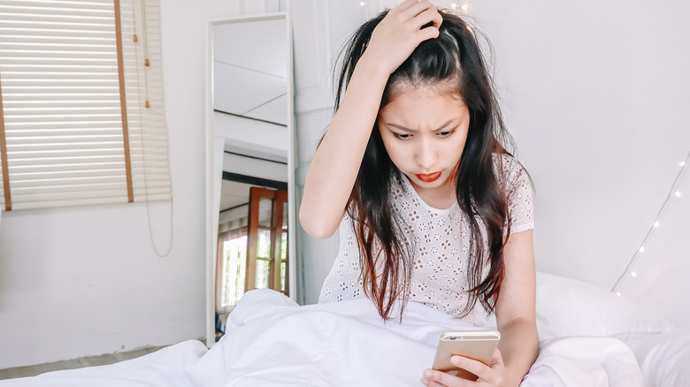 woman looking at phone