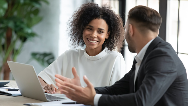 woman listening to man at work