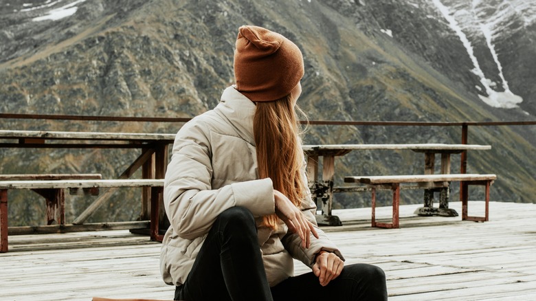 sitting woman looking at mountain