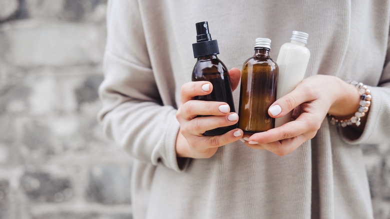 Woman holding body oils