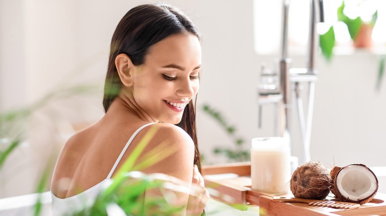 Woman in bathroom with coconut